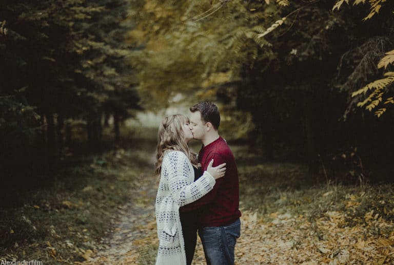 couple kissing on pathway