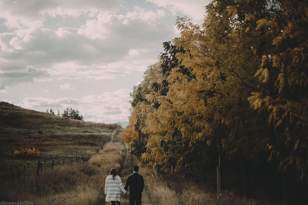 couple walking down a field