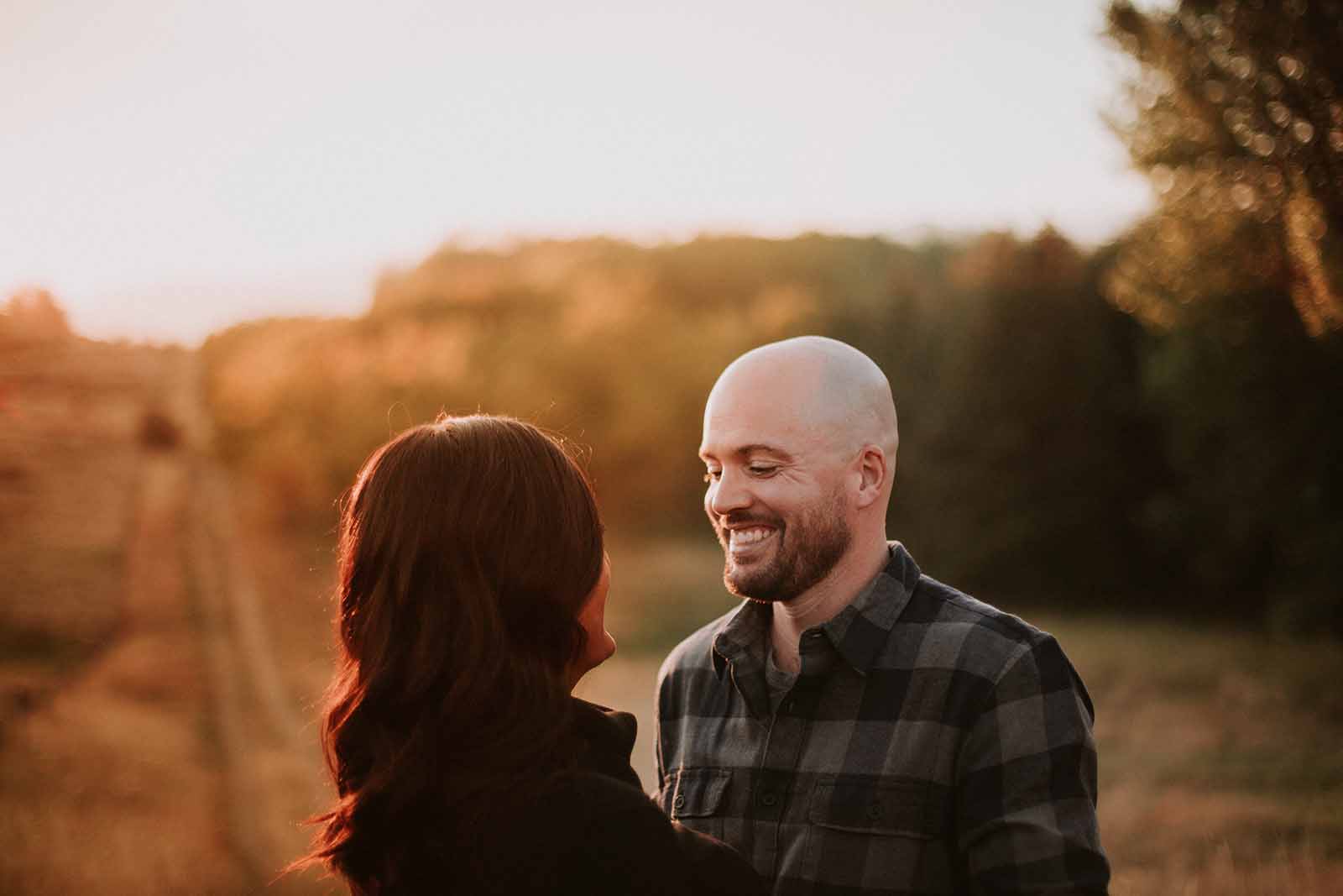 Couple laughing as they look at each-other