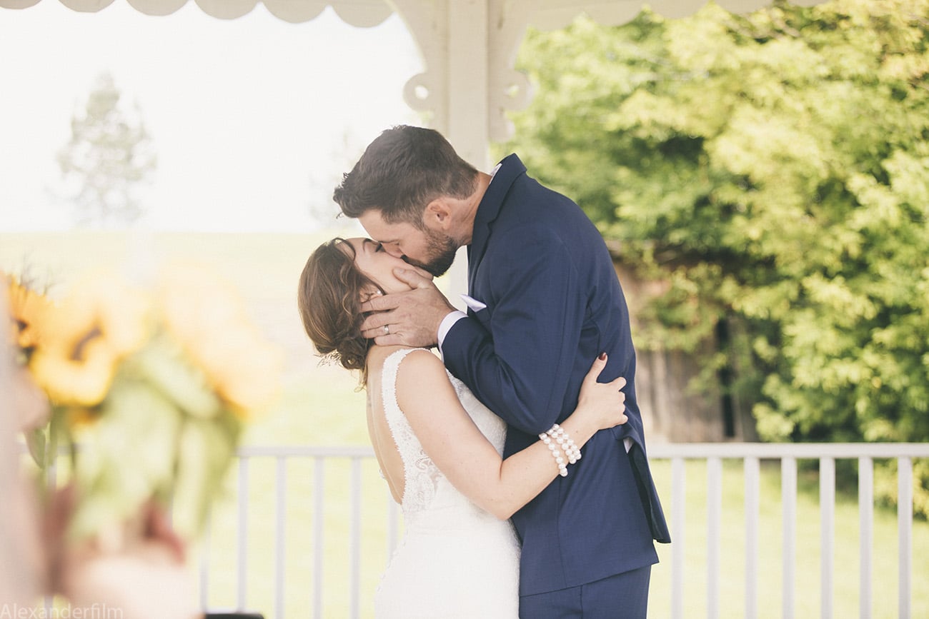 a bride and groom kissing for the first time