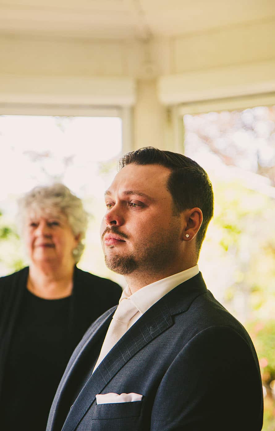 a groom crying at a ceremony