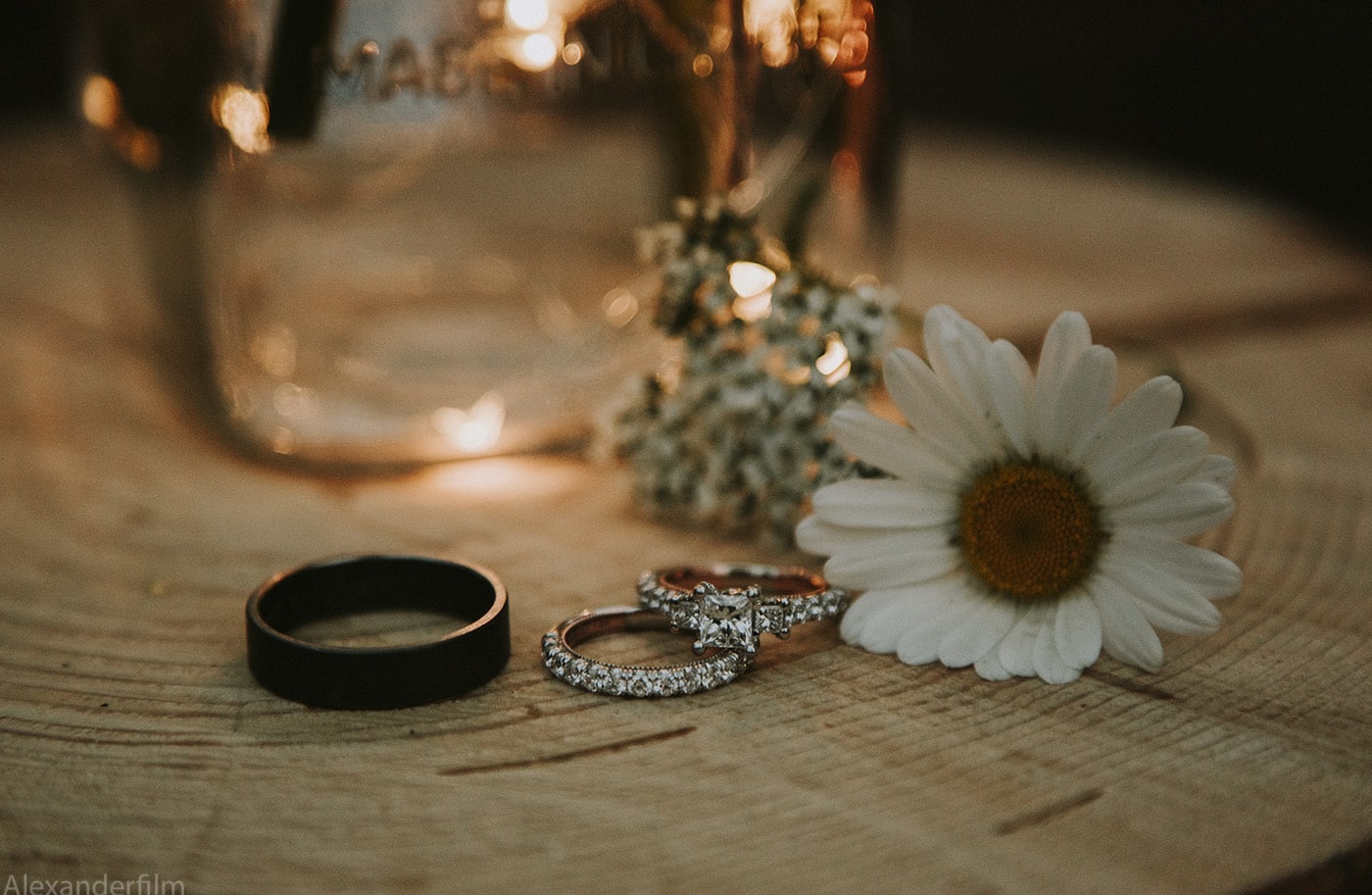flowers on a stump with wedding rings