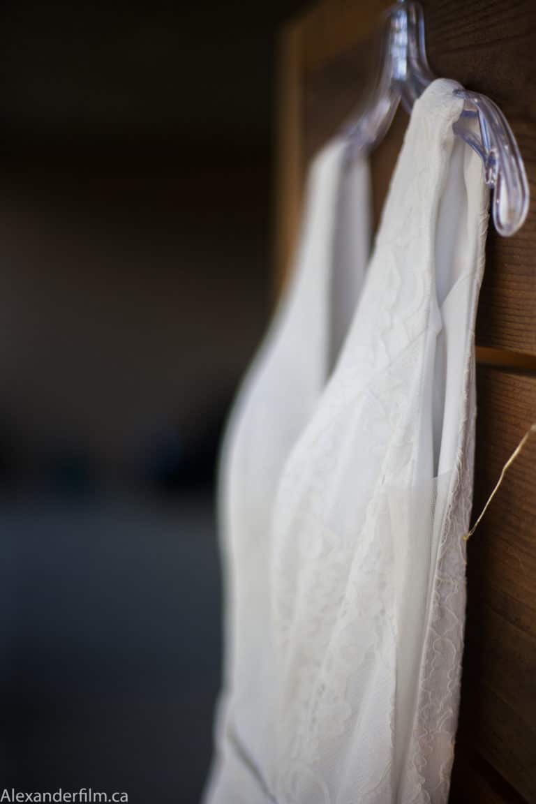 a wedding dress hanging on a hanger