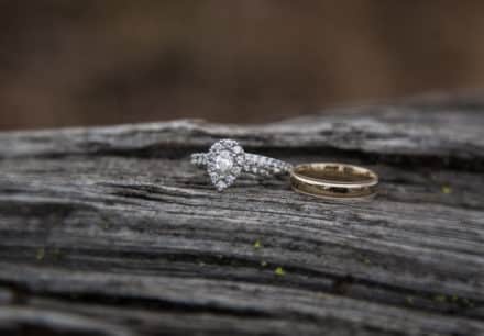 two wedding rings on some rustic wood