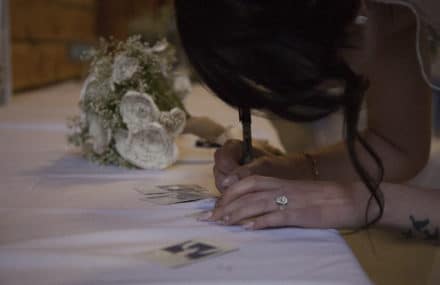 a bride signing photos on a table