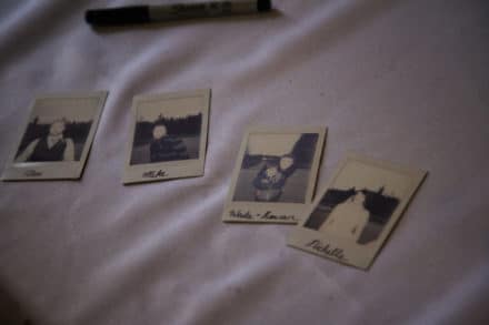 instant photos strewn across a table