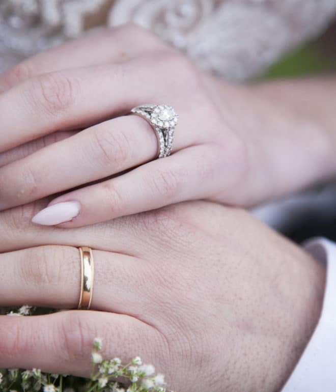 newly married couple hands on top of each-other