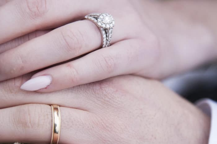 newly married couple hands on top of each-other