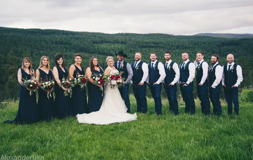 wedding party posing in front of camera for photo