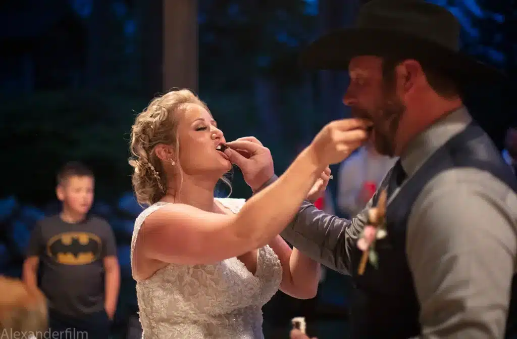 bride and groom feed each other cake after wedding
