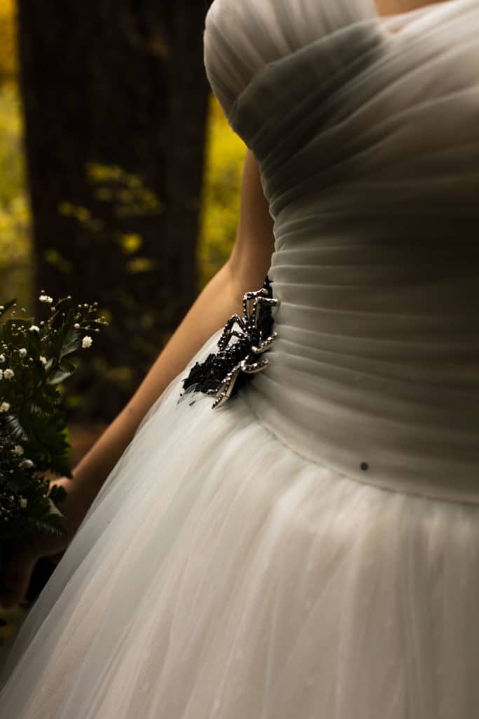 wedding dress with spider jewelry on waste