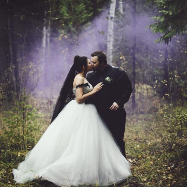 bride and groom kissing in the forest
