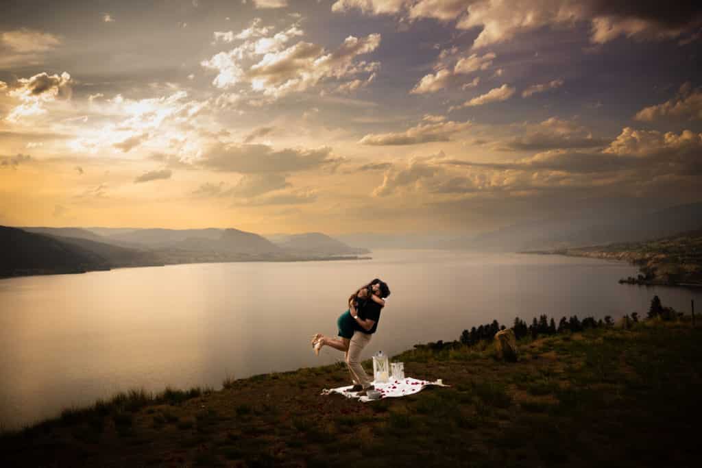 man holding woman sunset