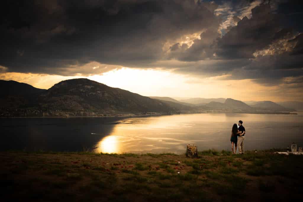 couple looking out towards lake sunset